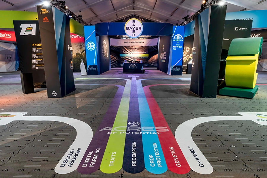 The entrance to Bayer Crop Science's multi-brand experience at the 2023 Farm Progress Show. Colored lines on the floor help direct booth visitors to the correct portion of the experience.